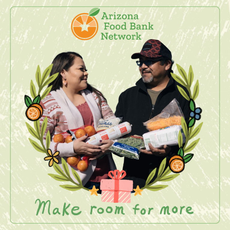 a couple holds a bounty of food