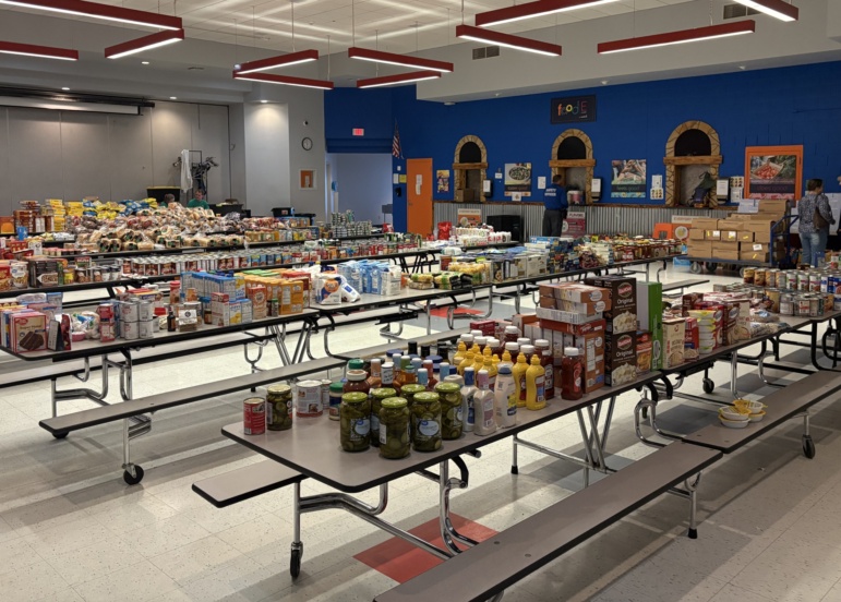 Tables of food are prepared for a thanksgiving pantry distribution in rural arizona